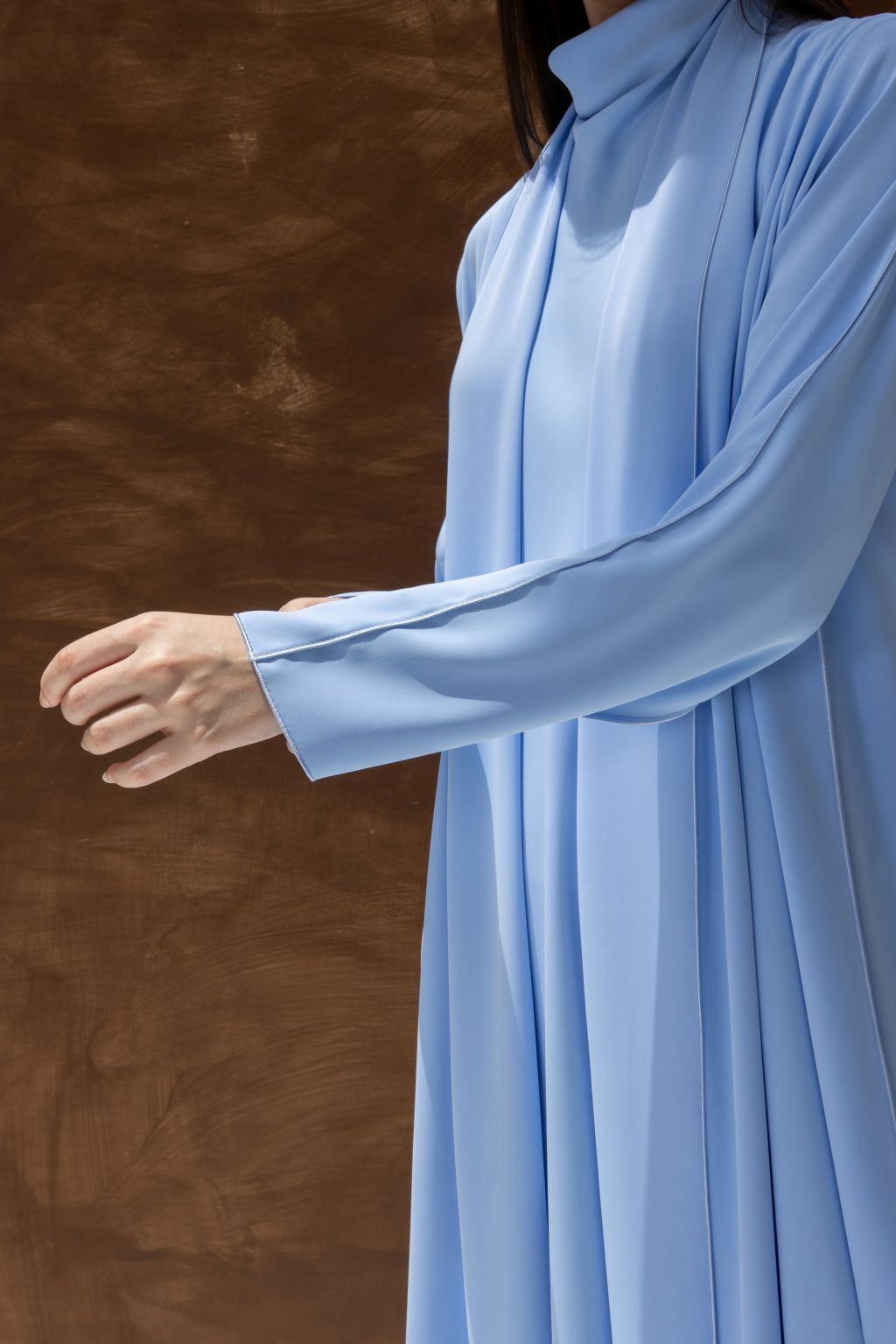 Selected Lines light blue abaya as a classic evening dress for special occasions with flowing fabric and long sleeves