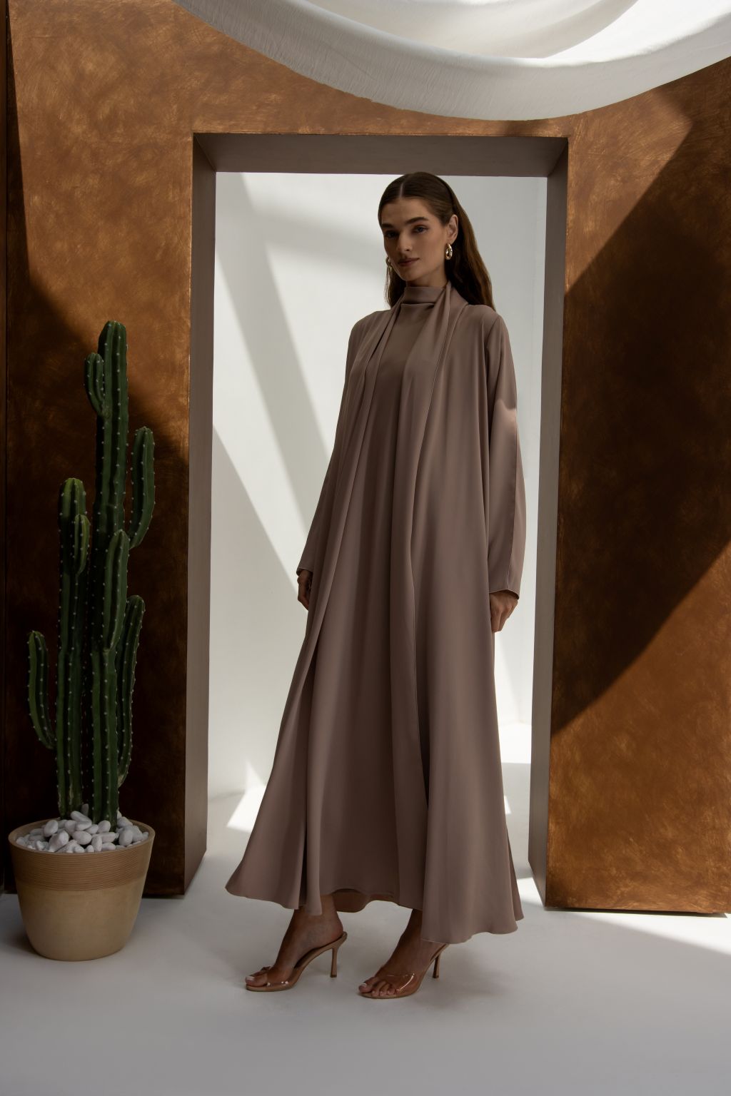 Selected Lines abaya in taupe worn by model styled as classic evening dress for special occasions