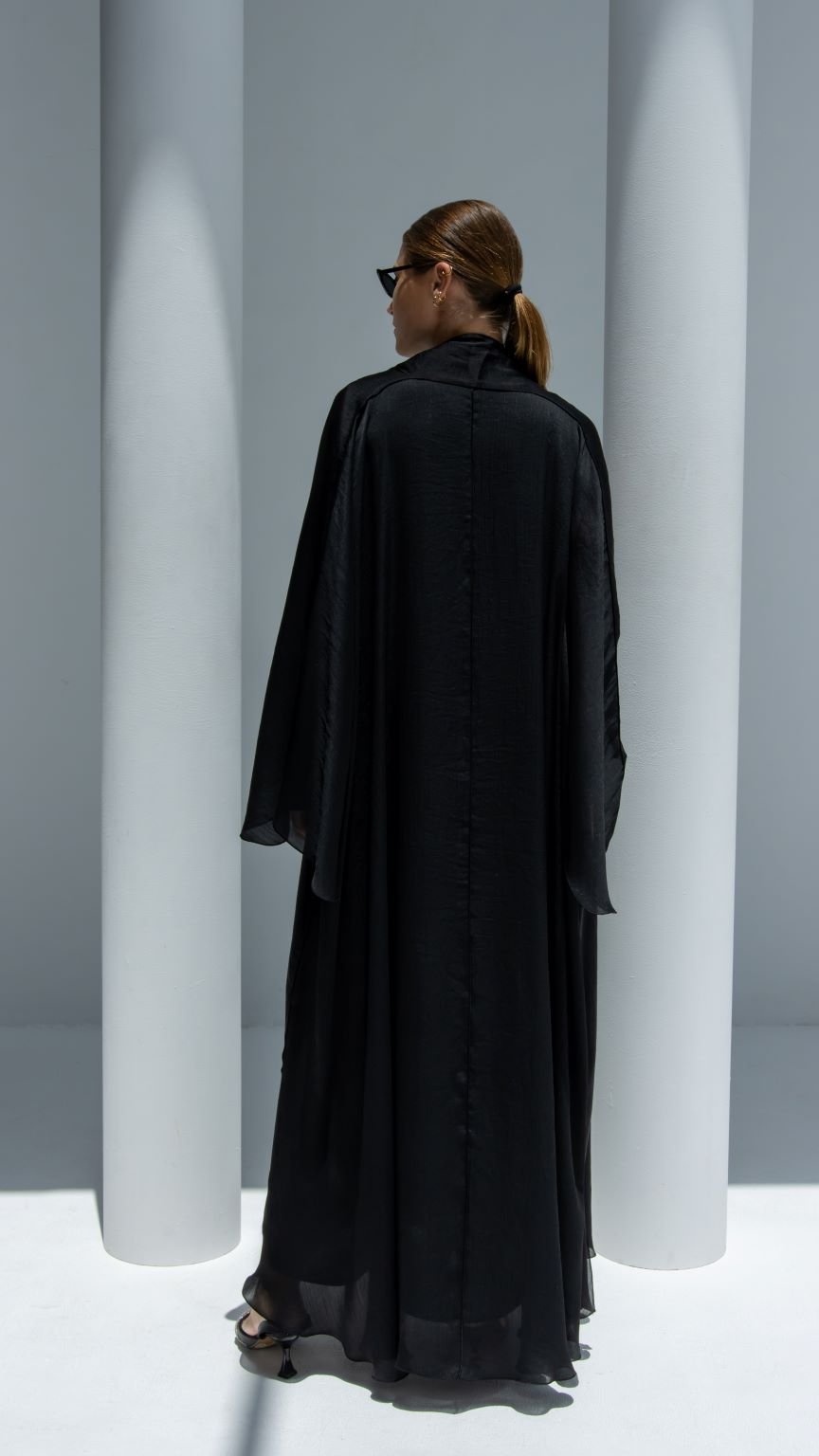 Back view of Afra Abaya showcasing the elegant fit cut and sleek black shiny lines material | Selected Lines