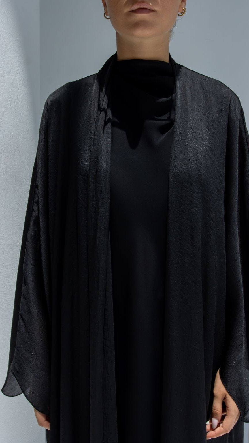 Close-up of Afra Abaya’s intricate black shiny lines fabric and fine craftsmanship | Selected Lines