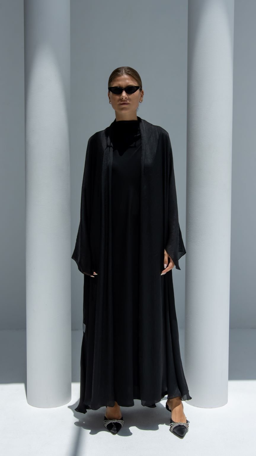 Front view of Afra Abaya in black shiny lines fabric with fit cut design | Selected Lines