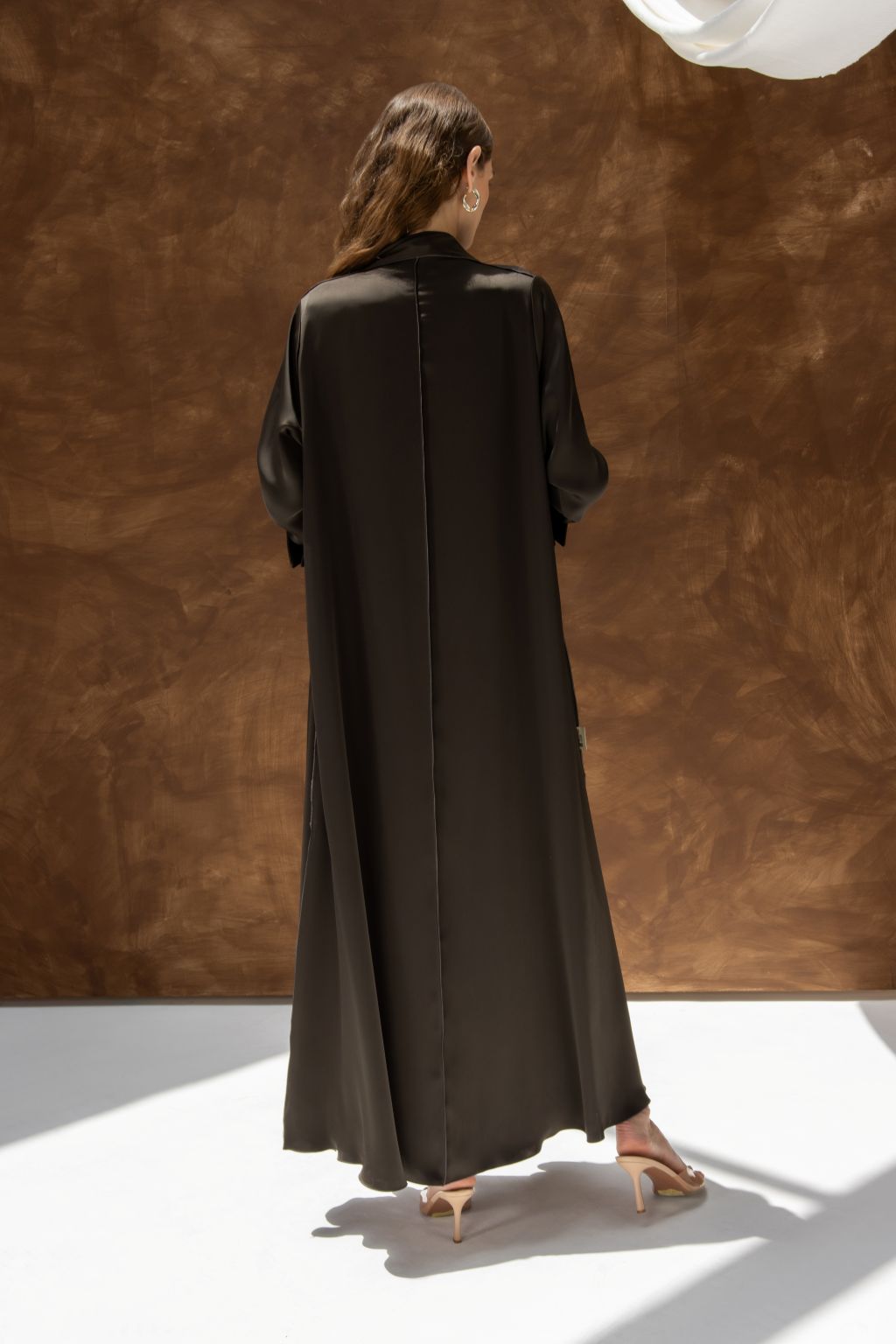 Selected Lines black elegant evening dress abaya with long sleeves and flowing design shown from back