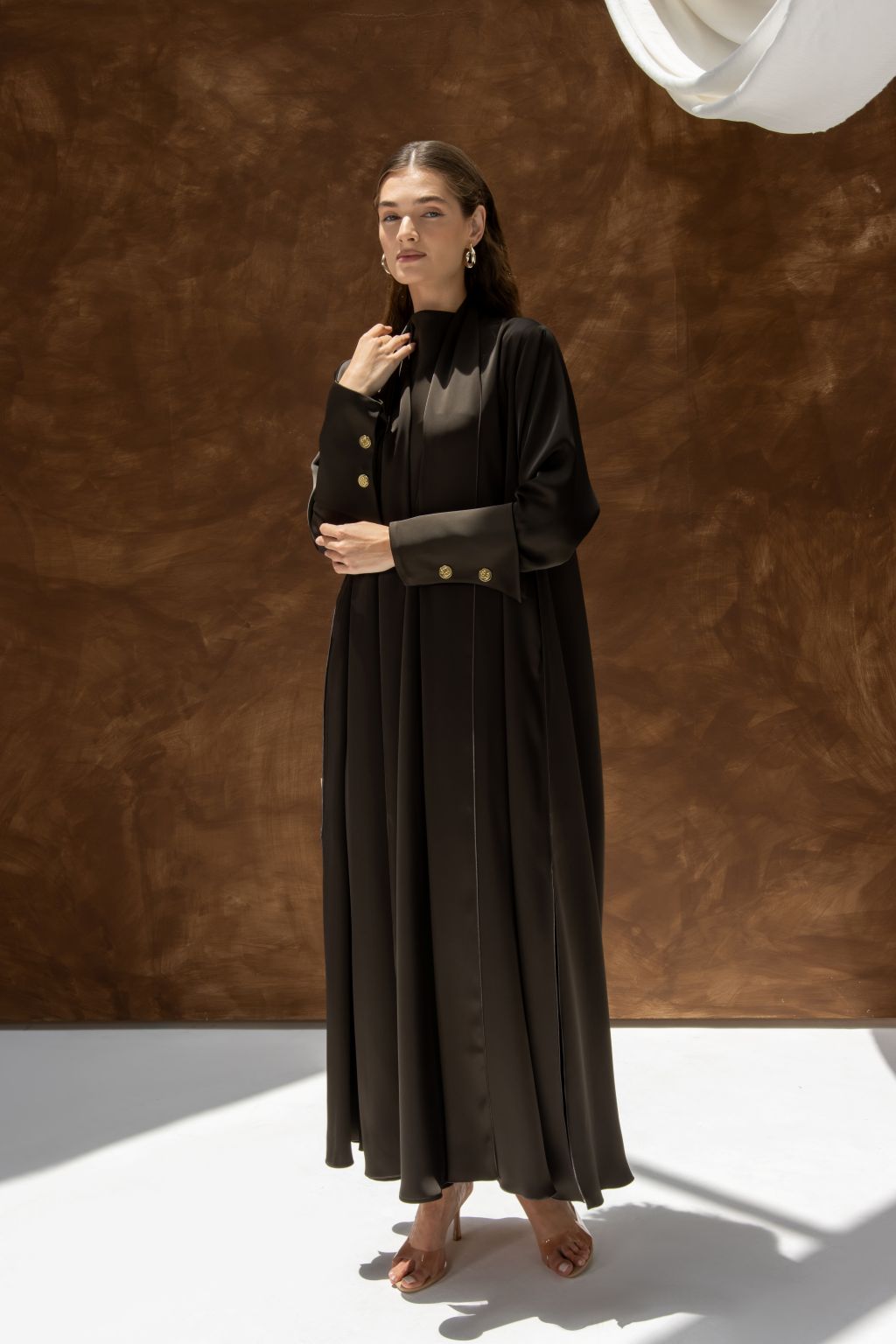 Selected Lines black elegant evening dress abaya with gold button details on cuffs worn by model