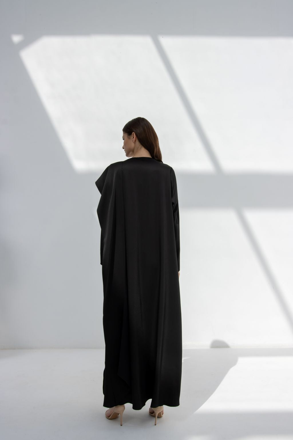 Selected Lines elegant flip wing abaya in black shown from back with long flowing design