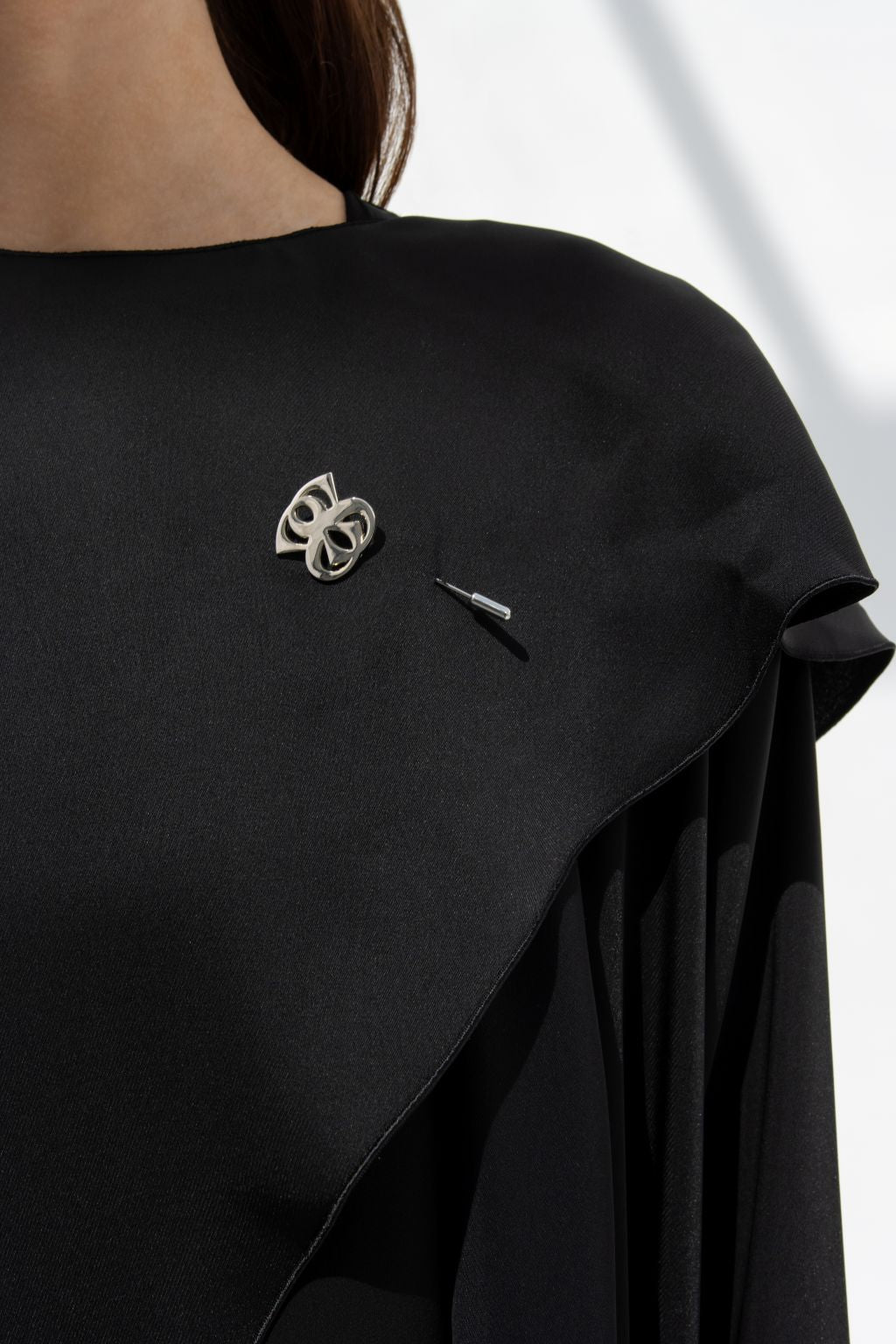 Selected Lines elegant flip wing abaya in black fabric featuring unique silver brooch detail