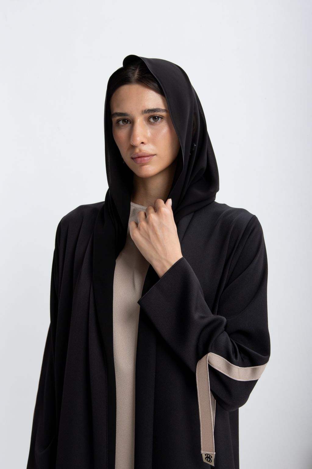 Elegant black designer abaya dress for occasions featuring a stylish hood and chic details