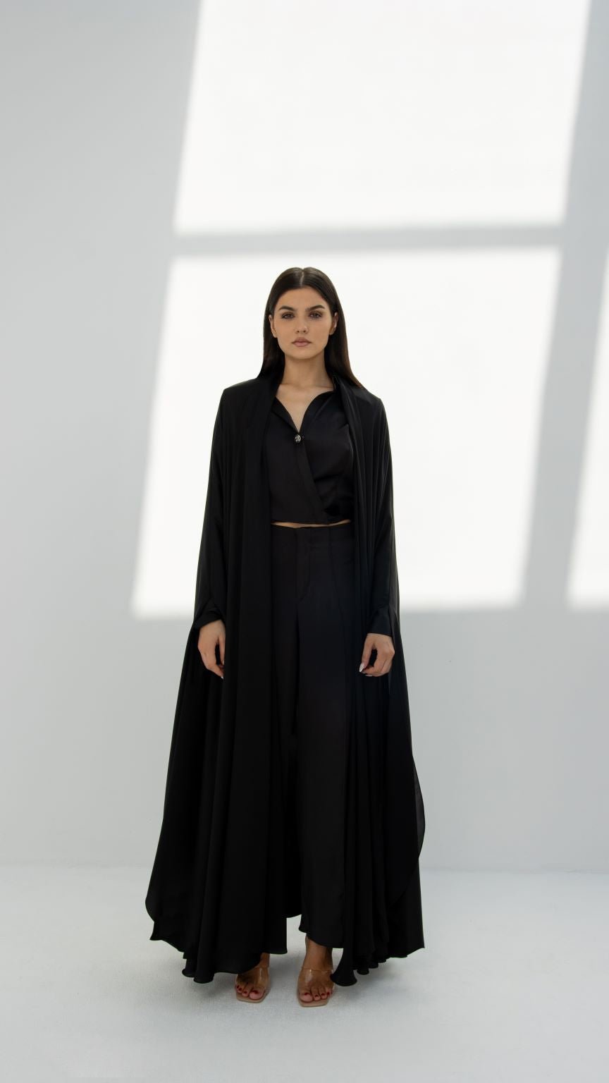 Woman wearing a long black abaya from Selected Lines showcasing elegant abaya designs