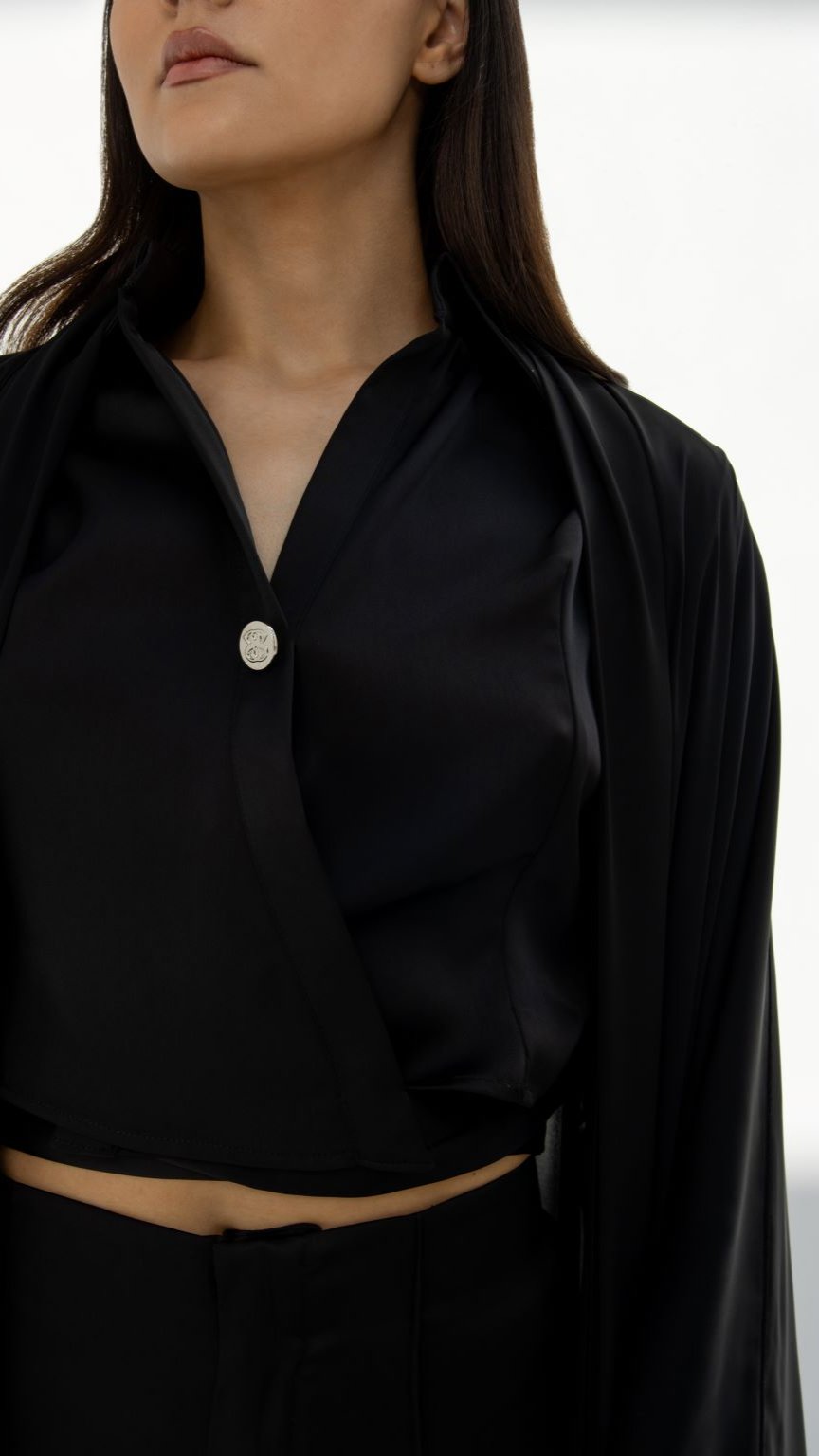 Black elegant abaya designs by Selected Lines featuring a sleek button detail and smooth fabric
