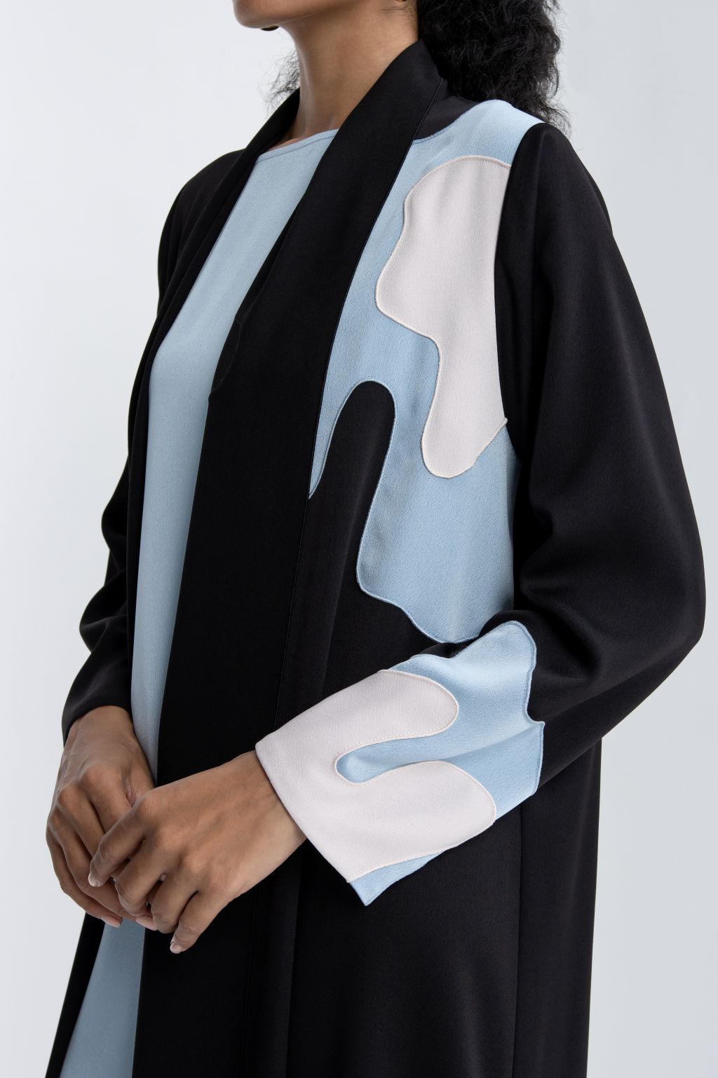 Elegant black and blue abaya featuring a stylish design with unique sleeve details