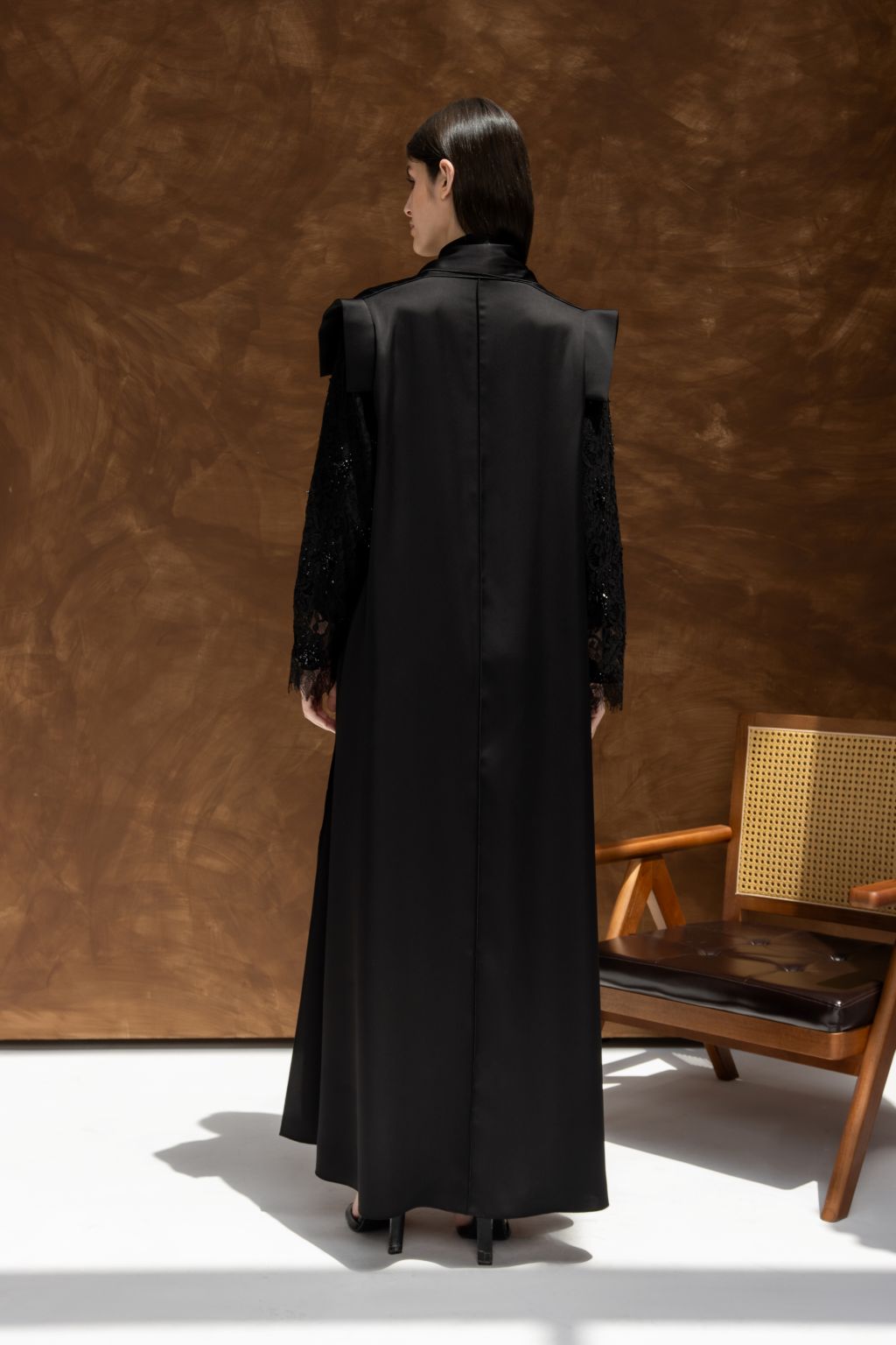 Elegant black evening dress by Selected Lines featuring a chic back design and detailed sleeves