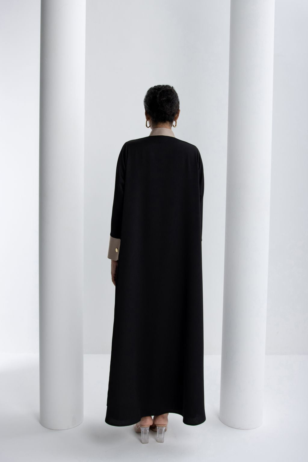Back view of an elegant black modest abaya with beige accents, designed for stylish modest fashion.