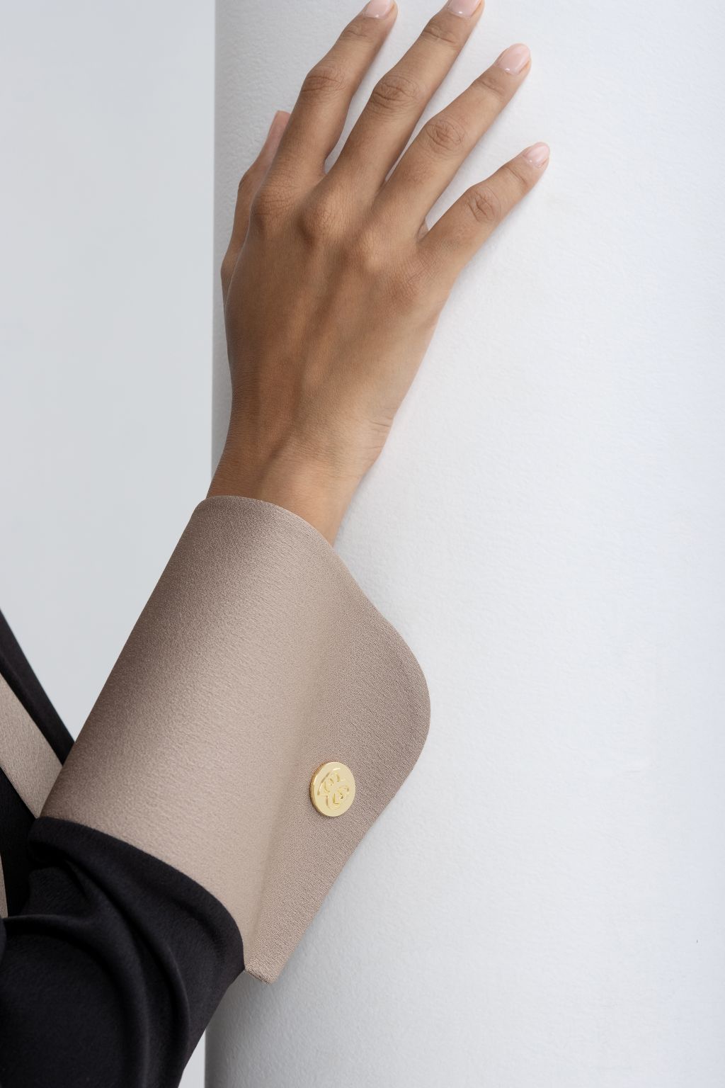 Close-up of the cuff detail on an elegant black modest abaya with a contrasting beige finish