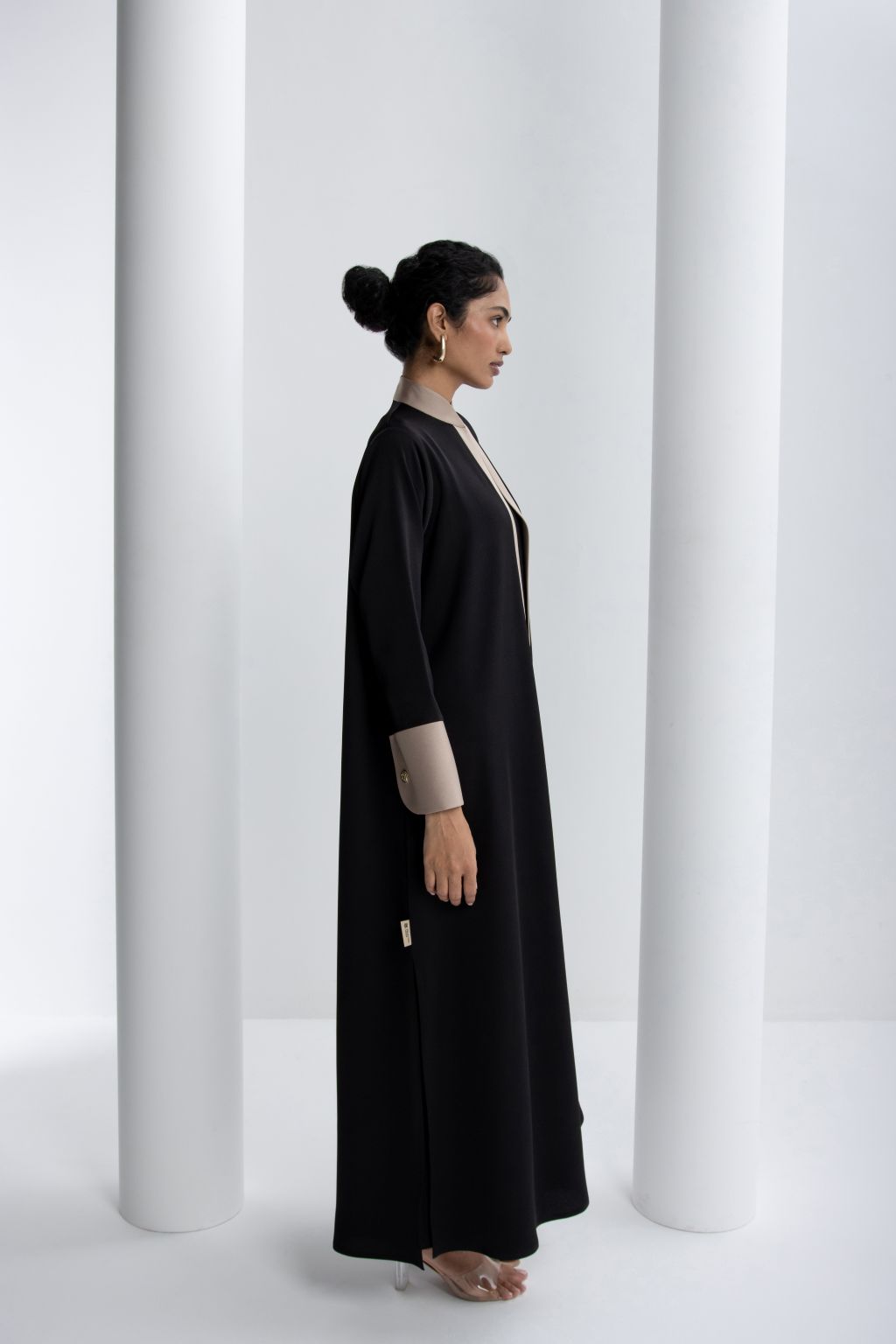 Elegant black modest abaya with slim fit design and contrasting cuffs for a timeless look