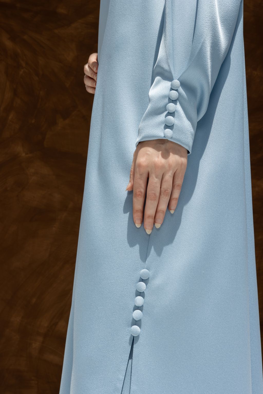 Selected Lines elegant Buttoned Breeze blue abaya showing detailed fabric buttons on sleeve and side
