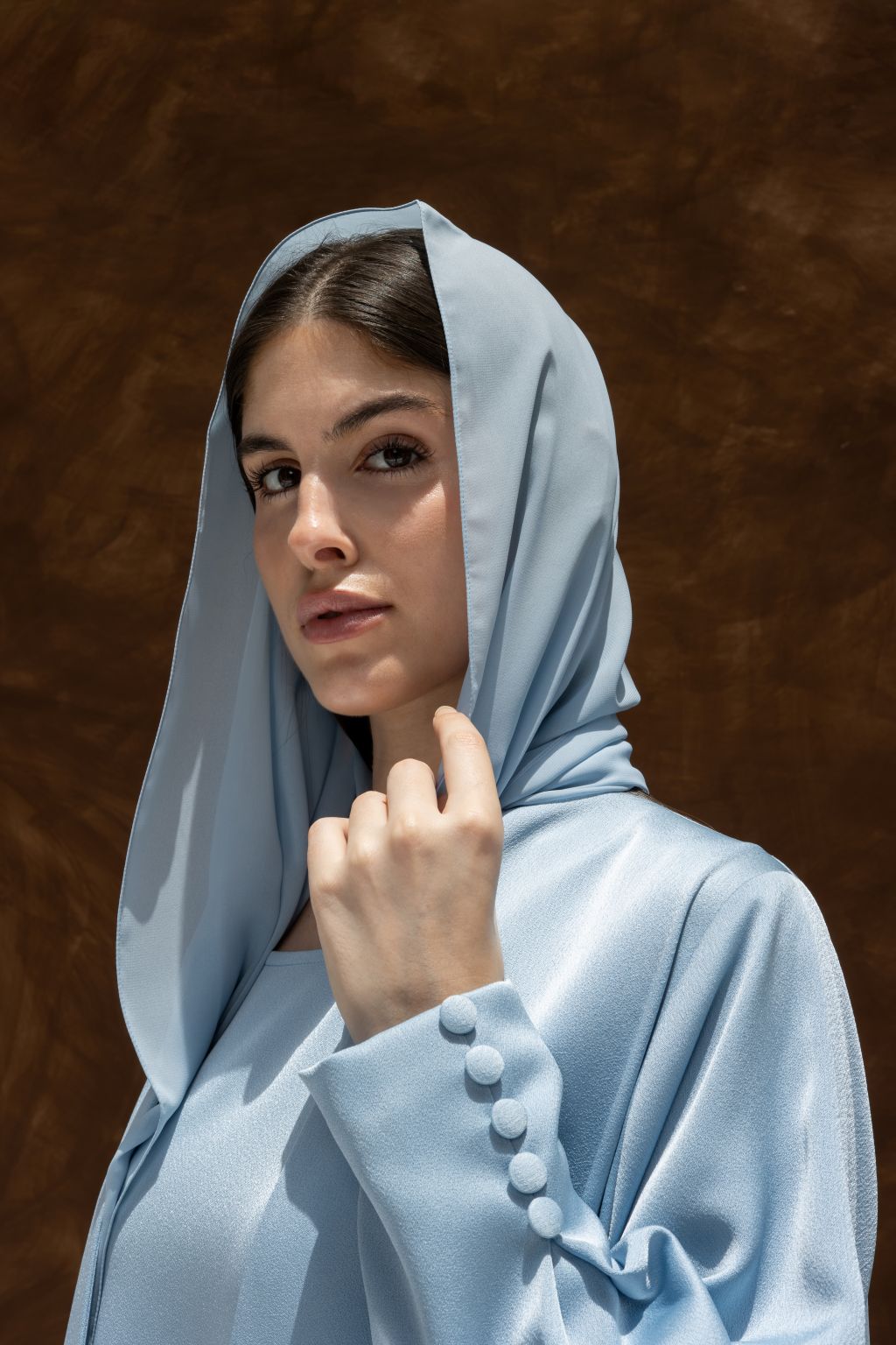 Elegant Buttoned Breeze blue abaya by Selected Lines with buttoned cuff and hood detail