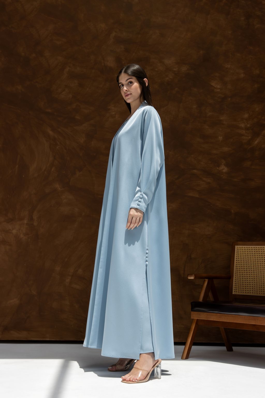 Selected Lines elegant Buttoned Breeze blue abaya worn by model with long sleeves and side button details