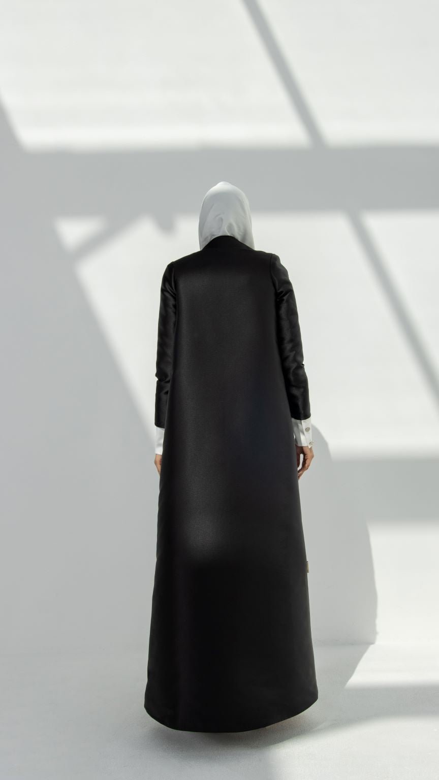 Back view of Elegant Coat Abaya showcasing the elegant coat-style design and non-stretchy taffeta material | Selected Lines