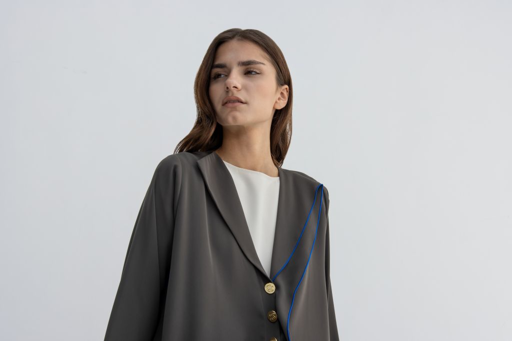 Selected Lines elegant Curve Buttons abaya in dark fabric with gold buttons worn by model