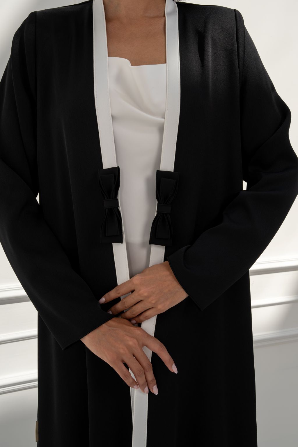 Selected Lines elegant formal outerwear for women featuring black abaya with stylish white accents