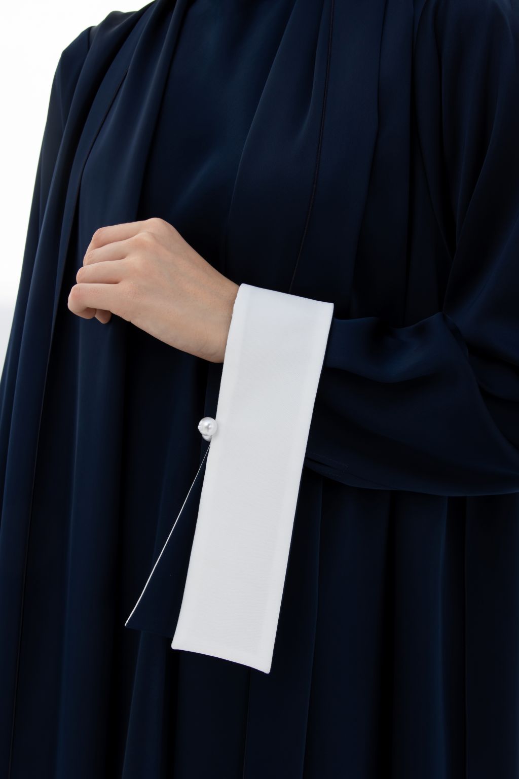 Elegant navy abaya featuring wide white cuffs, perfect as elegant modest wear for women