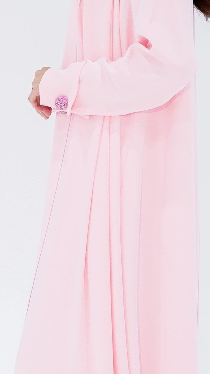 Elegant pearl buttons abaya in soft pink featuring flowing fabric and stylish cuffs