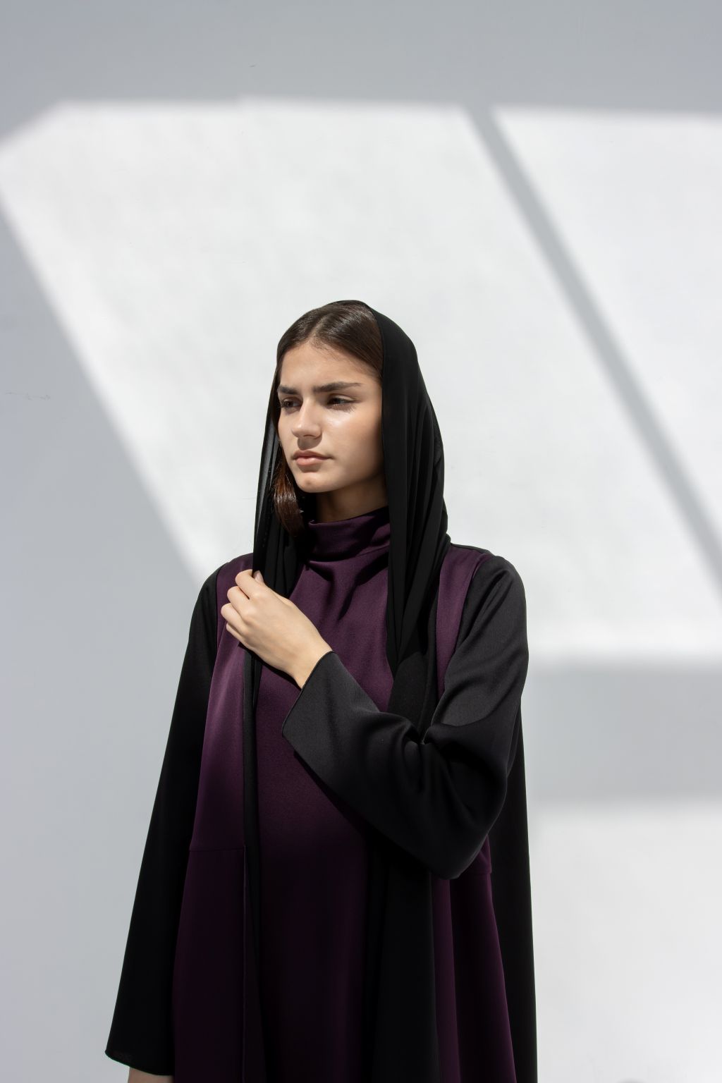 Selected Lines elegant purple abaya with black sleeves and hood worn by model in soft natural light