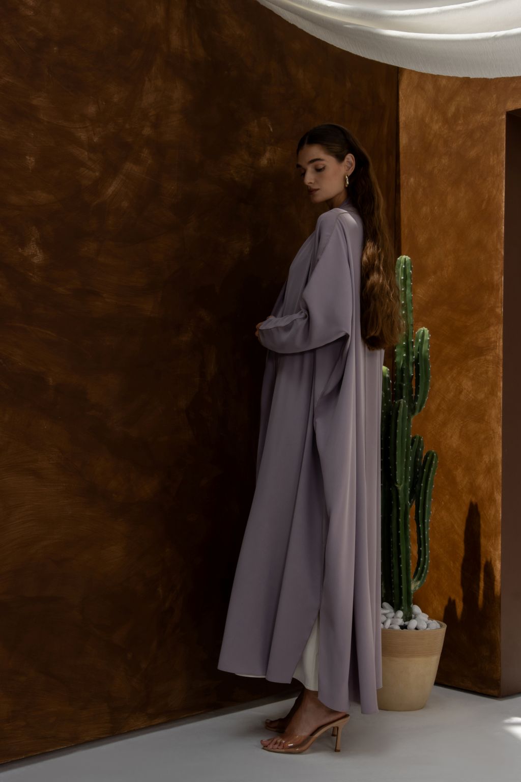Selected Lines elegant signature abaya in soft lavender color worn by model with long hair and heels