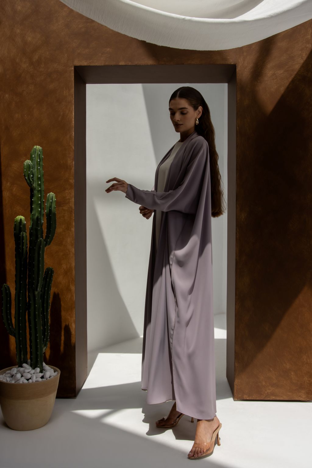 Selected Lines elegant signature abaya in soft lavender color worn by woman with long hair and heels