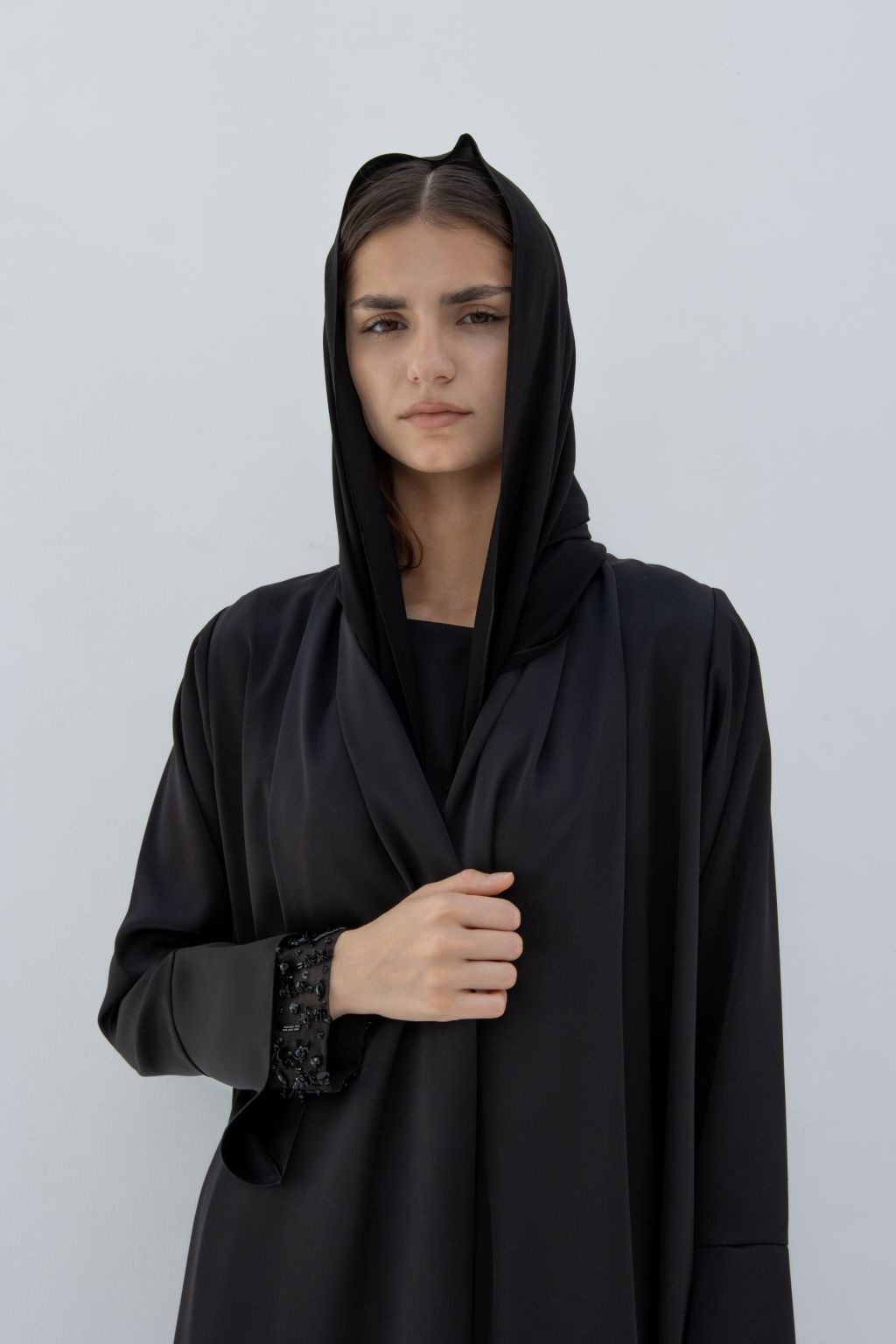 Selected Lines black abaya with elegant sleeve crystals abaya design worn by a model with hood