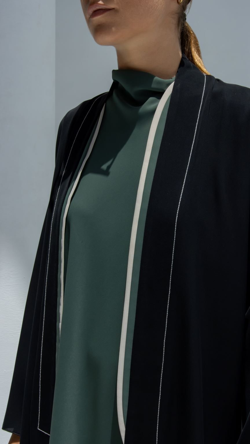 Elegant two lines abaya in black with chic white detailing for a modern look