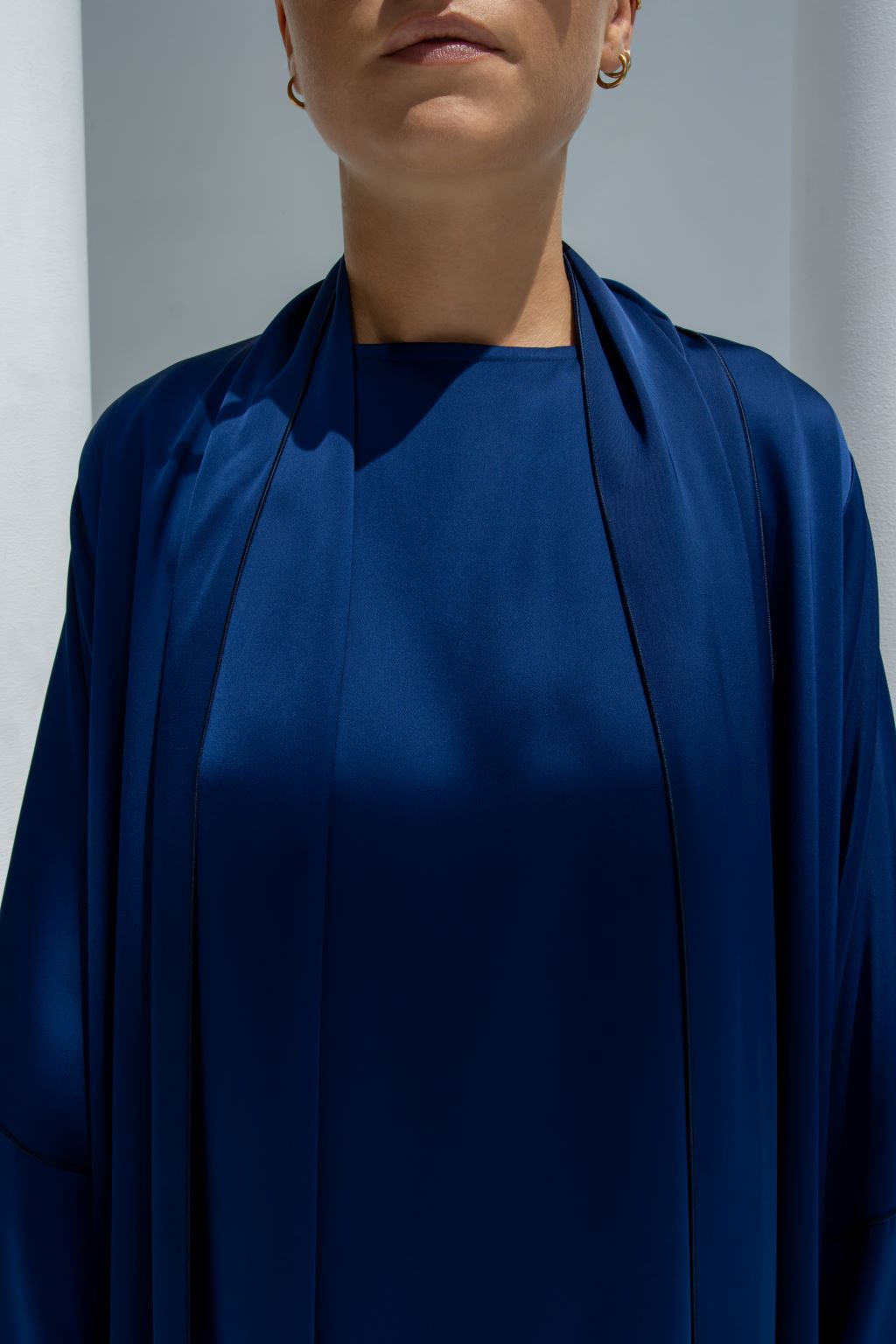 Close-up of Fouz Abaya’s blue shiny crepe fabric and sleeve detailing | Selected Lines
