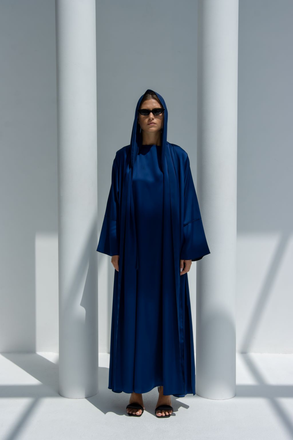 Front view of Fouz Abaya in elegant blue shiny crepe fabric with mermaid cut sleeves | Selected Lines
