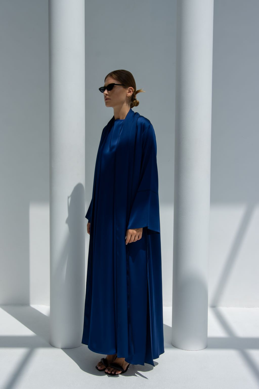 Side profile of Fouz Abaya highlighting the mermaid cut sleeves and shiny crepe material | Selected Lines