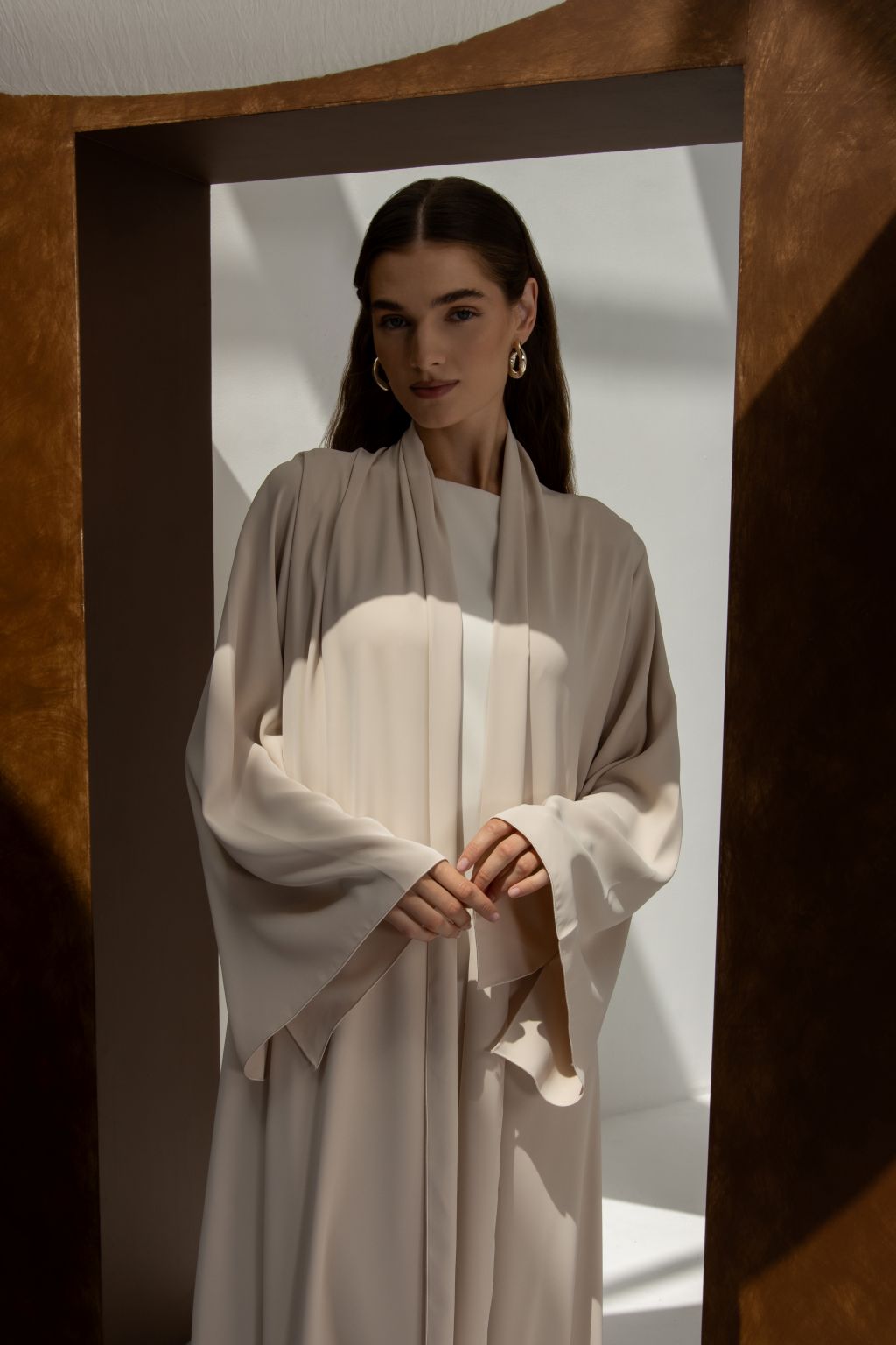 Elegant women’s Franci abaya by Selected Lines in light beige with flowing sleeves and draped design