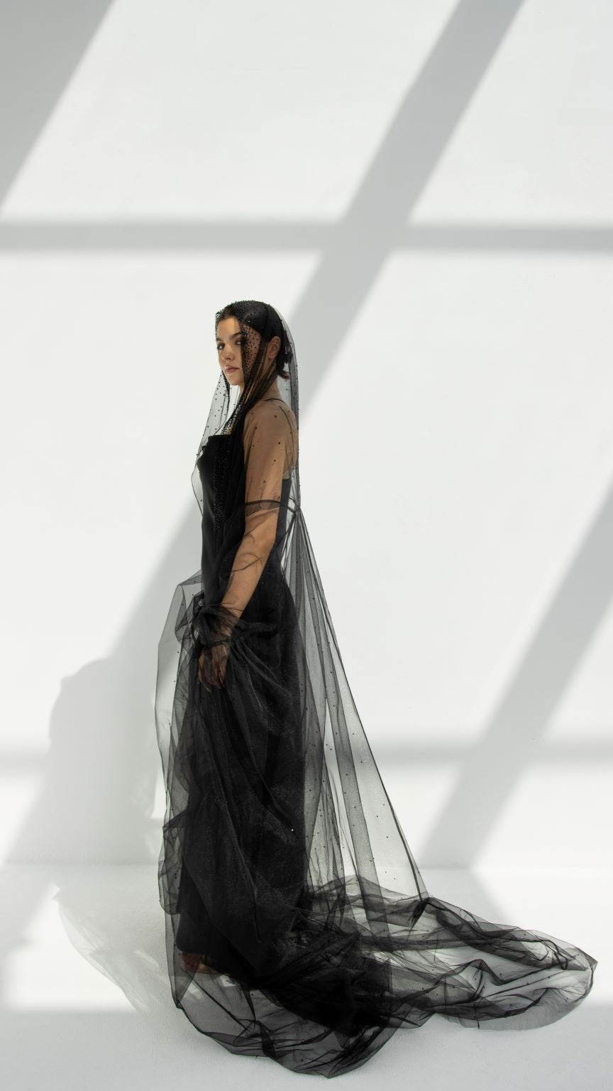 Georgina Abaya elegant design with flowing black fabric and a stylish veil in soft light
