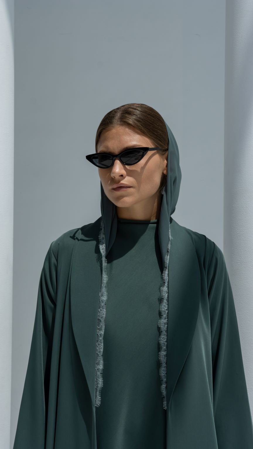 Close-up of Half Lace Abaya’s intricate floral lace design on dark green crepe fabric | Selected Lines