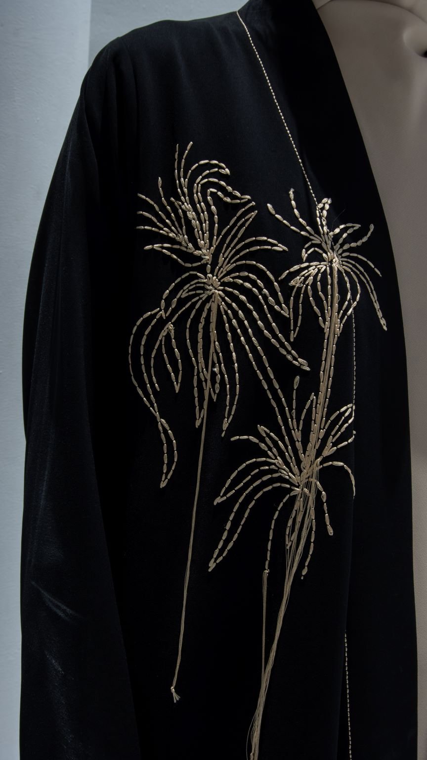 Close-up of Hanging Flowers Abaya’s intricate thread design on luxurious black crepe fabric | Selected Lines