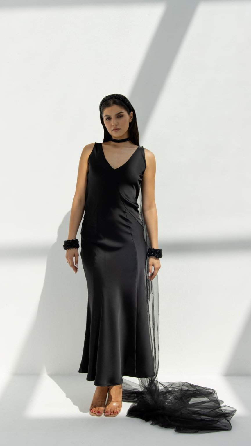 Selected Lines black high-end choker gown with flowing train worn by model against white background
