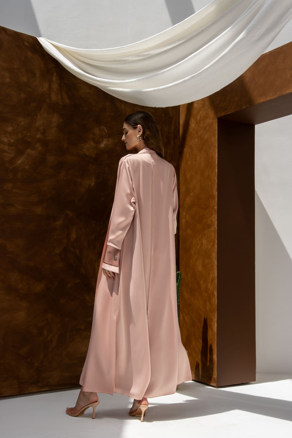 Selected Lines high quality formal abaya in soft pink worn by woman with elegant heels