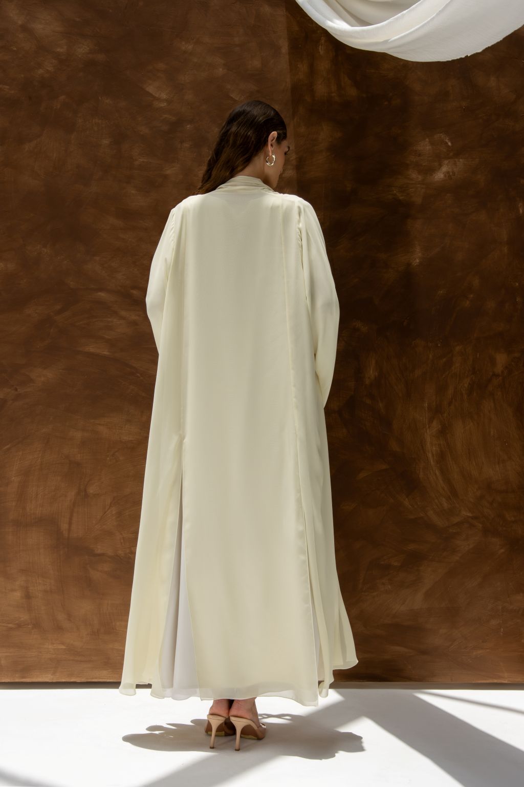 Selected Lines Layered Grace Abaya in cream color with flowing fabric and long sleeves shown from back
