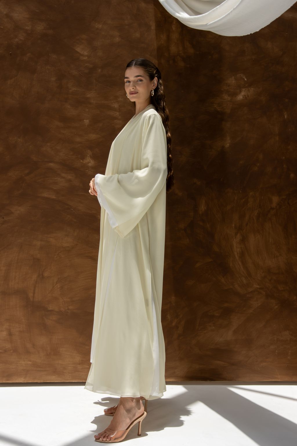 Selected Lines Layered Grace Abaya in soft cream with flowing sleeves worn by model