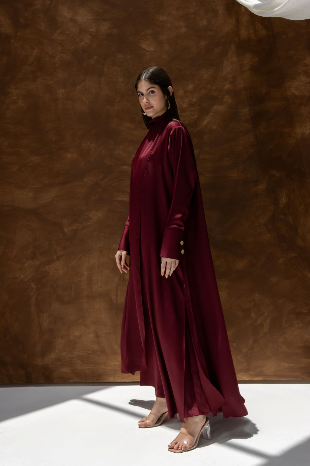 Selected Lines luxury abaya dress for women in deep burgundy with long sleeves and gold button details