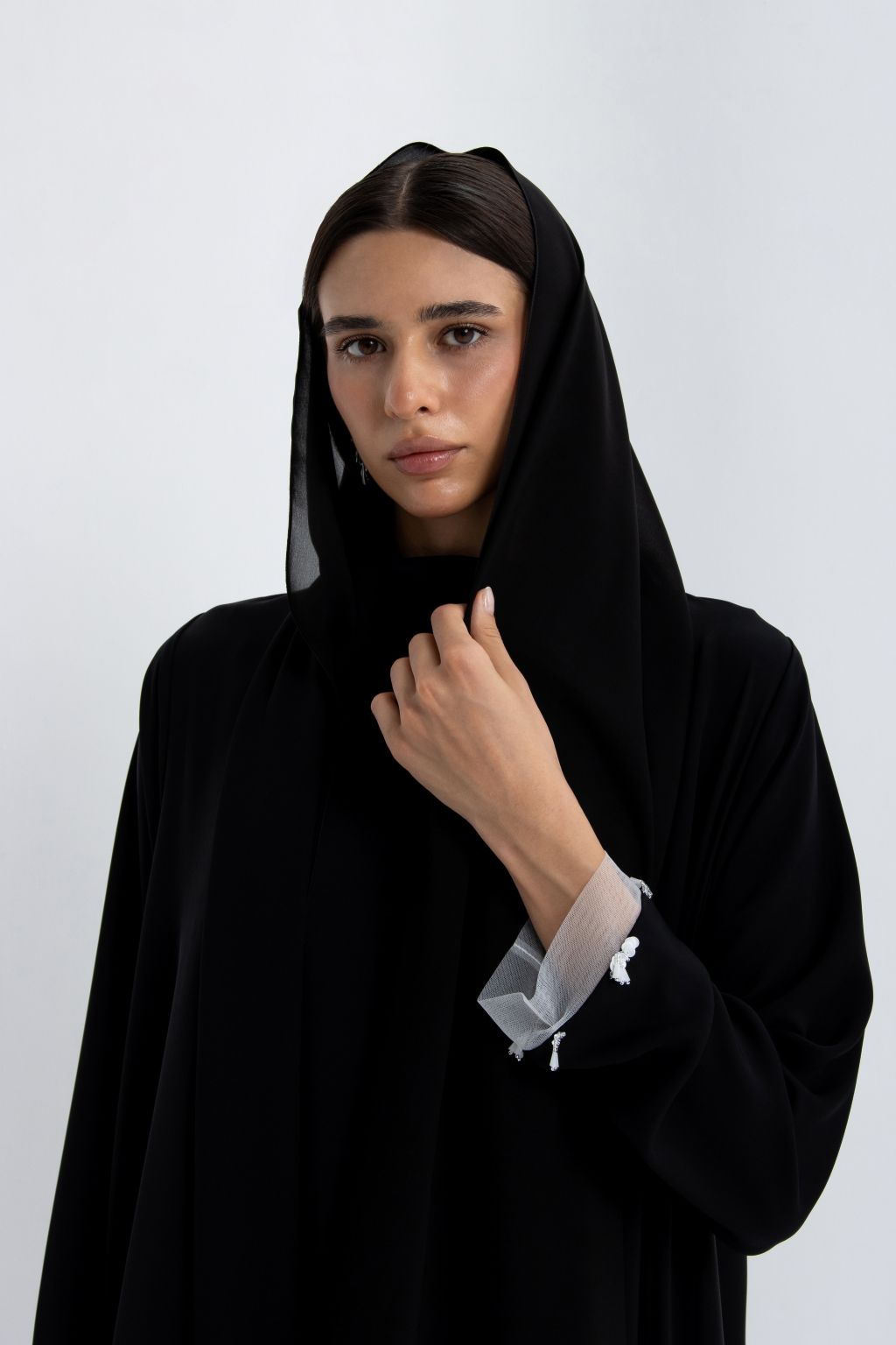 Elegant luxury black abaya for women with delicate detailing on sleeves and a stylish hood