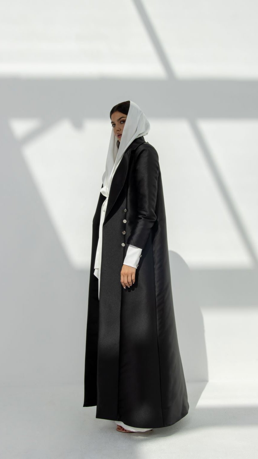 Elegant luxury black abaya for women featuring button details and a flowing design