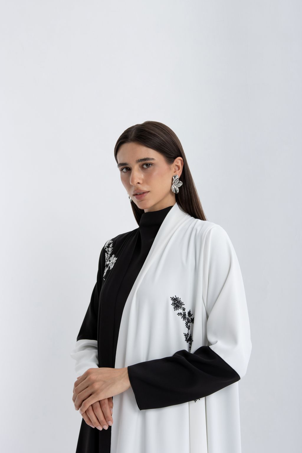 Stylish luxury black and white abaya featuring elegant embroidery and a modern design