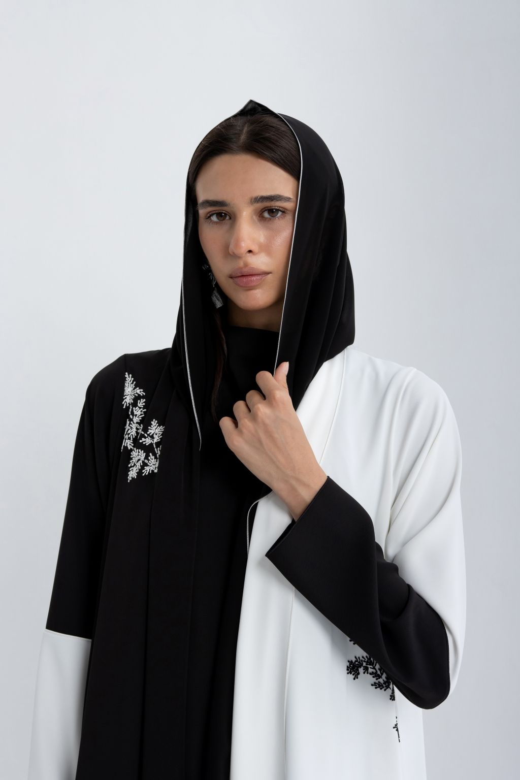 Elegant luxury black and white abaya featuring intricate embroidery and a stylish design