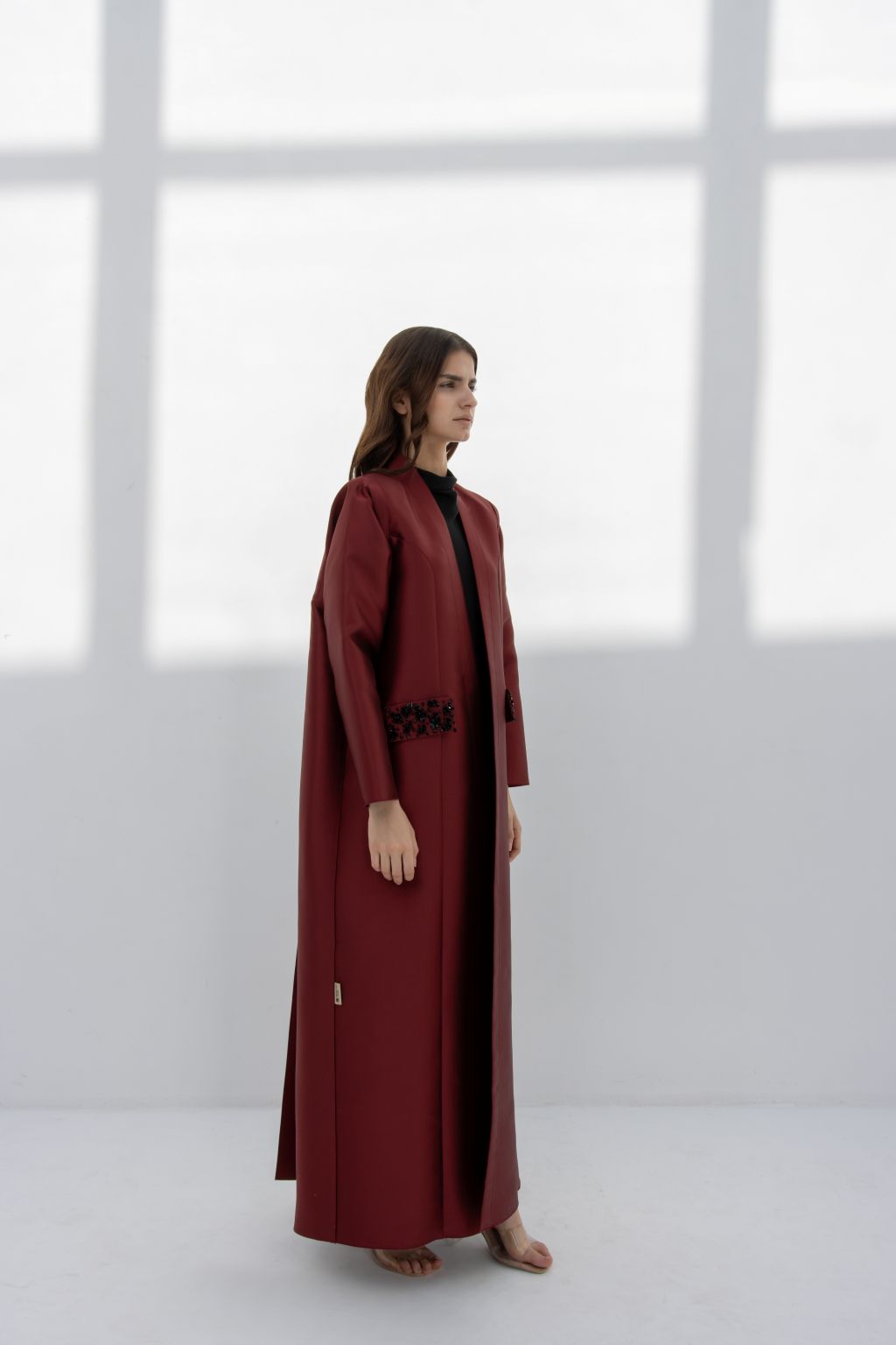 Luxury burgundy women's coat from Selected Lines with elegant design and flowing silhouette