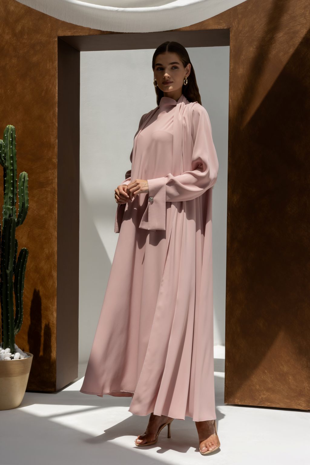 Selected Lines luxury buttoned abaya in light pink with long sleeves and high neckline