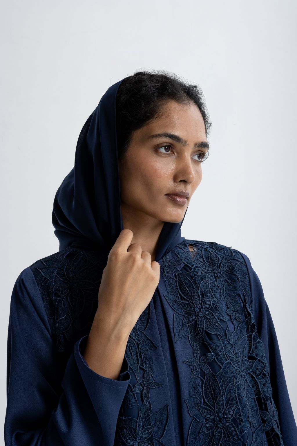 Luxury embroidered abaya in navy with intricate floral designs and a matching hood for elegant wear