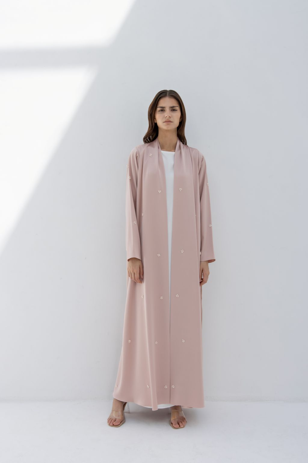 Selected Lines luxury fashion abaya in soft pink with minimalist design worn by model